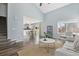 Bright living room with wood floors, a large window, and view into the dining and kitchen area at 19844 E Vassar Ave, Aurora, CO 80013