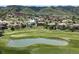 Gorgeous aerial view of a luxury home community built alongside a lush green golf course and pond at 7188 Raphael Ln, Littleton, CO 80125