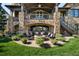 Spacious backyard with outdoor seating around a fire pit and detailed stonework at 7188 Raphael Ln, Littleton, CO 80125