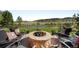 Outdoor seating area with a fire pit and beautiful landscaping at 7188 Raphael Ln, Littleton, CO 80125