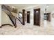 Spacious basement with tile floors, staircase, decorative columns, display shelving, and a bar area at 7188 Raphael Ln, Littleton, CO 80125