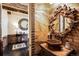 Artistic powder room featuring unique design elements, including designer mirror and wall textures at 7188 Raphael Ln, Littleton, CO 80125