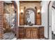 Luxurious bathroom with stone shower, brick archways, and elegant wood vanity at 7188 Raphael Ln, Littleton, CO 80125