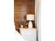 Detailed view of a bedroom nightstand featuring a lamp, plants, and decorative elements at 7188 Raphael Ln, Littleton, CO 80125