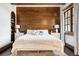 Charming bedroom with wood accent wall, hardwood floors, and decorative touches at 7188 Raphael Ln, Littleton, CO 80125