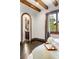 Cozy bedroom entryway featuring decorative brick, hardwood floors, and natural light at 7188 Raphael Ln, Littleton, CO 80125