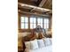 Elegant bedroom featuring a decorative headboard, exposed brick wall and decorative ceiling at 7188 Raphael Ln, Littleton, CO 80125