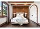 Inviting bedroom with hardwood floors, wood accent wall, and a cozy ambiance at 7188 Raphael Ln, Littleton, CO 80125