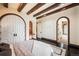 Bedroom showcasing beamed ceilings and multiple arched doorways at 7188 Raphael Ln, Littleton, CO 80125