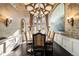 Elegant dining room featuring a large dining table, chairs, chandelier, and windows, perfect for Gathering meals at 7188 Raphael Ln, Littleton, CO 80125