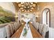 Grand dining room with a long table, decorative lighting, and intricate wall details at 7188 Raphael Ln, Littleton, CO 80125