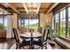 Elegant dining room with wood floors, decorative ceiling, and scenic views from large windows at 7188 Raphael Ln, Littleton, CO 80125
