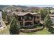 Stunning stone home with a tile roof, outdoor patio and landscaped backyard in a mountain setting at 7188 Raphael Ln, Littleton, CO 80125