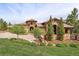 Beautiful stone and stucco home with mature landscaping and a circular driveway at 7188 Raphael Ln, Littleton, CO 80125