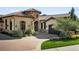 Stunning home featuring a stone turret, tile roof, and lush landscaping at 7188 Raphael Ln, Littleton, CO 80125