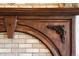 Close-up of a meticulously crafted fireplace with wood mantle and brick surround at 7188 Raphael Ln, Littleton, CO 80125