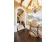 Grand foyer with a mural, a decorative chandelier, brick accents, stone archways, and hardwood floors at 7188 Raphael Ln, Littleton, CO 80125