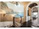 Grand foyer with mural, staircase, wrought iron railing, and chandelier at 7188 Raphael Ln, Littleton, CO 80125