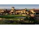 Stunning view of a golf course and clubhouse with stone architecture at 7188 Raphael Ln, Littleton, CO 80125
