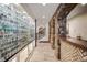 Hallway features stone accents, tiled floor, display cabinets and a staircase at 7188 Raphael Ln, Littleton, CO 80125