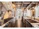 Gourmet kitchen with professional-grade appliances and a stone arch over the range at 7188 Raphael Ln, Littleton, CO 80125