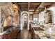 Beautiful kitchen featuring granite countertops, custom cabinetry, and a stone range hood at 7188 Raphael Ln, Littleton, CO 80125