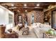 Cozy living area with a decorative ceiling, brick walls, built-in shelving, and comfortable seating at 7188 Raphael Ln, Littleton, CO 80125