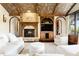 Inviting living room featuring a stone fireplace, custom woodwork, and comfortable seating at 7188 Raphael Ln, Littleton, CO 80125