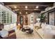 The living room showcases unique brick and stone textures along with custom ceilings and decor at 7188 Raphael Ln, Littleton, CO 80125