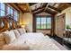 Serene main bedroom with a large bed, scenic views, and stylish decor at 7188 Raphael Ln, Littleton, CO 80125