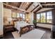 Beautiful main bedroom with vaulted ceilings, large windows, and an ornate bed frame, creating a luxurious retreat at 7188 Raphael Ln, Littleton, CO 80125