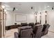 Home movie theater with leather recliners, wall sconces and large projection screen at 7188 Raphael Ln, Littleton, CO 80125