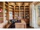 Cozy home office with built-in bookshelves, a wooden desk, and decorative accents at 7188 Raphael Ln, Littleton, CO 80125