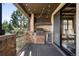 Covered outdoor kitchen with a built-in grill, countertop space, and scenic views of the surrounding landscape at 7188 Raphael Ln, Littleton, CO 80125