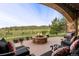 Scenic outdoor living space featuring a stone fire pit and stunning mountain views at 7188 Raphael Ln, Littleton, CO 80125