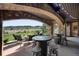 Outdoor patio with seating area, fire pit and scenic mountain views at 7188 Raphael Ln, Littleton, CO 80125