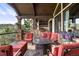 Inviting covered patio featuring comfortable seating, a fire pit, and an outdoor kitchen area at 7188 Raphael Ln, Littleton, CO 80125