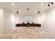 Spacious theater room features custom cabinets, a large screen, and recessed lighting for an immersive experience at 7188 Raphael Ln, Littleton, CO 80125