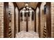 Unique wine cellar with brick walls, custom wine racks, and barrel accents at 7188 Raphael Ln, Littleton, CO 80125