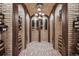 Beautiful wine cellar with brick walls, arched doorways and overhead lighting at 7188 Raphael Ln, Littleton, CO 80125