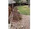 Landscaped backyard with garden beds lined with brick and gravel ground cover at 11375 W Maplewood Ave, Littleton, CO 80127