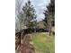 Spacious backyard with a well-manicured lawn, garden beds, and a wooden bench at 11375 W Maplewood Ave, Littleton, CO 80127