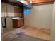 Unfinished basement featuring exposed ductwork, small window and storage with a wooden cabinet, ready for customization at 11375 W Maplewood Ave, Littleton, CO 80127