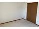 A clean and bright bedroom features neutral carpeting and a spacious closet at 11375 W Maplewood Ave, Littleton, CO 80127