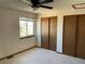 Bedroom with carpeted floor, window, ceiling fan and sliding closet doors at 11375 W Maplewood Ave, Littleton, CO 80127