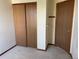 Bedroom featuring carpet, double closets and adjoining door at 11375 W Maplewood Ave, Littleton, CO 80127