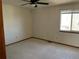 Empty bedroom features neutral carpet, window and ceiling fan at 11375 W Maplewood Ave, Littleton, CO 80127