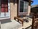 Exterior front porch area features metal table and chairs with covered bench seating at 11375 W Maplewood Ave, Littleton, CO 80127