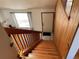 Entryway with wood stairs and railing, leading to a white front door and window at 11375 W Maplewood Ave, Littleton, CO 80127