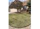 Charming home with a lush front lawn, a decorative tree, and a cozy front porch and flower bed at 11375 W Maplewood Ave, Littleton, CO 80127